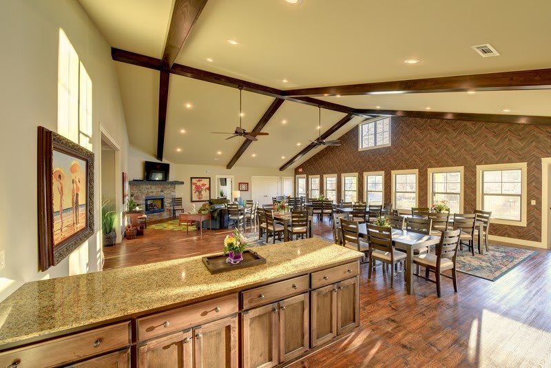 Spacious open-concept dining and kitchen area with wooden accents and modern furnishings.