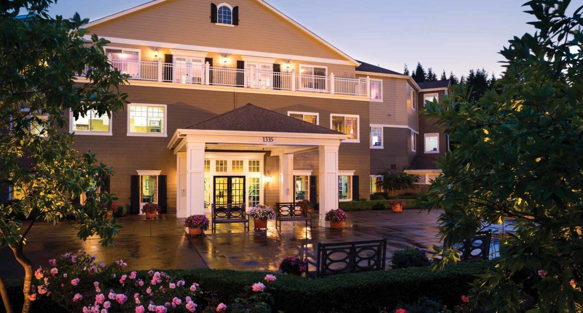Elegant hotel entrance illuminated in the evening.