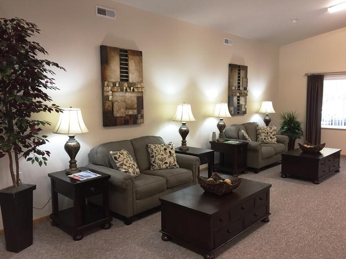A cozy living room with plush sofas, elegant lamps, and tasteful wall art.
