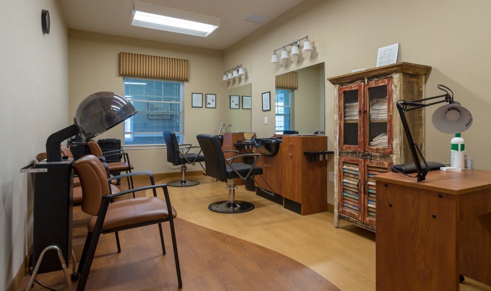Interior of a hair salon with styling chairs and mirrors.