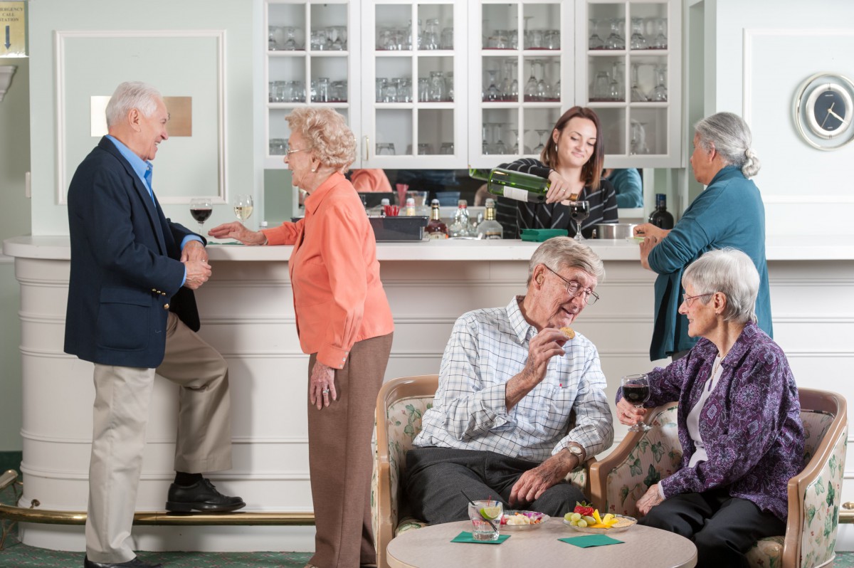 A group of seniors enjoying a social gathering in a cozy indoor setting.