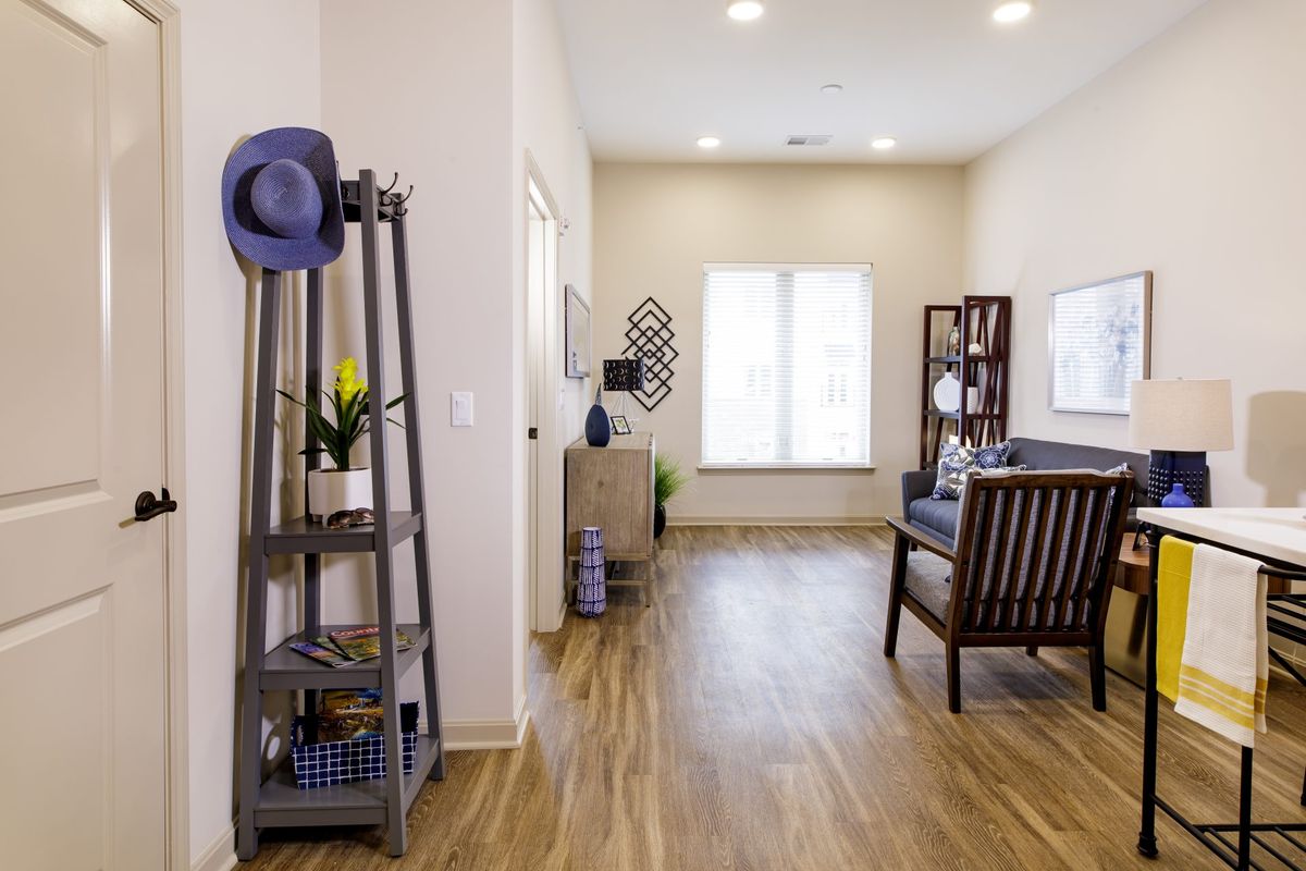 A bright and modern living room with wood flooring and stylish decor.