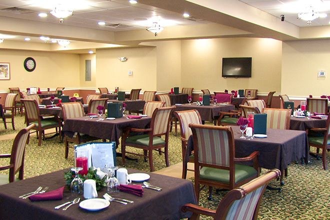 A well-arranged dining room with tables and chairs set for service.