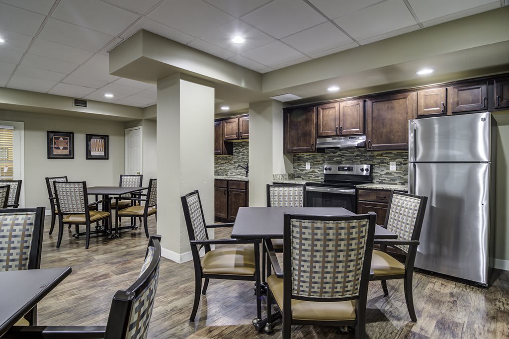 A modern kitchen and dining area with stylish furniture and lighting.