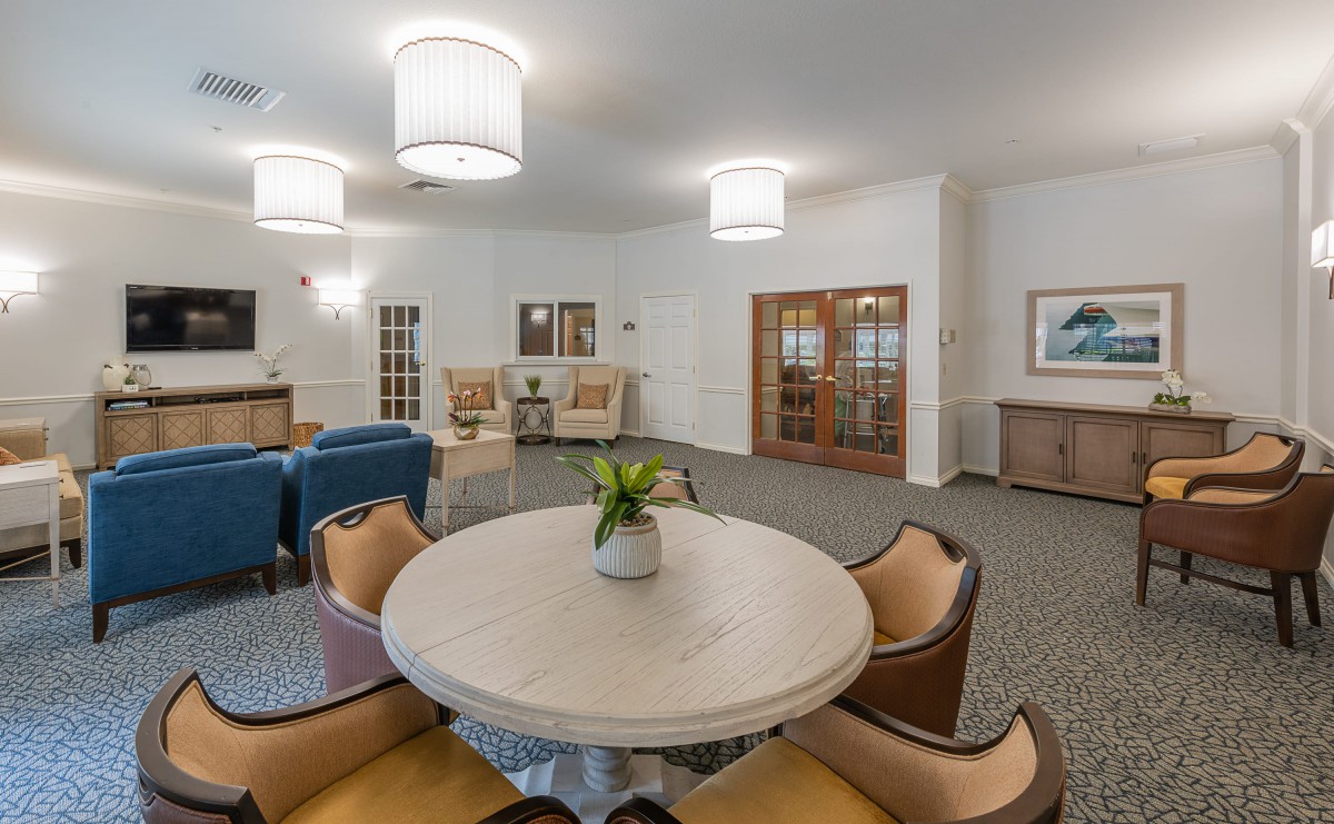 A modern living room with a round table and comfortable seating arrangements.