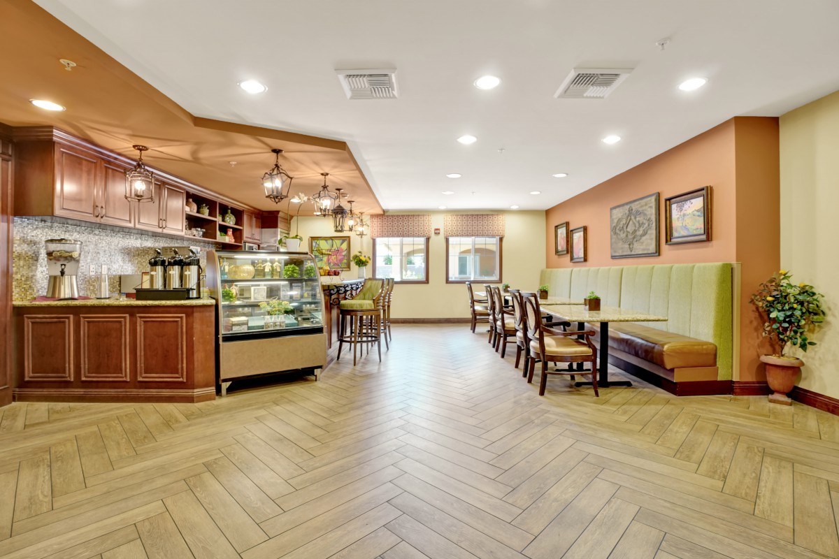 A cozy cafe interior with a seating area and display counter.
