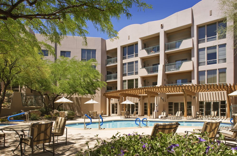 A sunny day at a hotel with an inviting outdoor pool area.