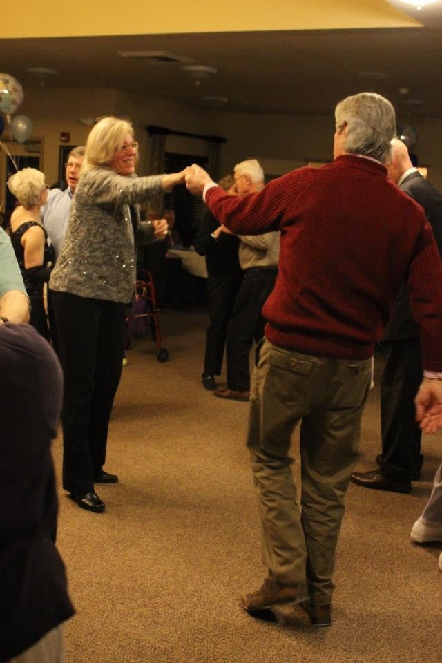 People enjoy dancing together at a social gathering.