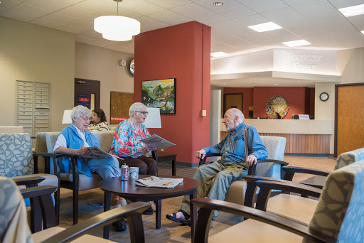 Seniors enjoying a moment of social interaction in a community lounge.