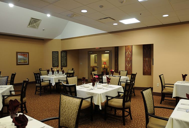 A well-arranged restaurant dining area with neatly set tables and comfortable chairs.