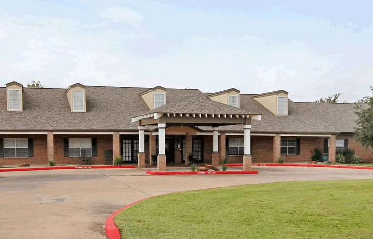 A building with a prominent entrance and landscaped surroundings.