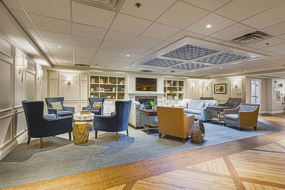 A cozy lounge area with comfortable seating and bookshelves.