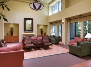 Spacious living room with comfortable seating and large windows.