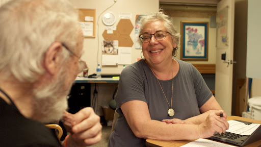 Two individuals engaged in a cheerful conversation, highlighting a moment of connection.