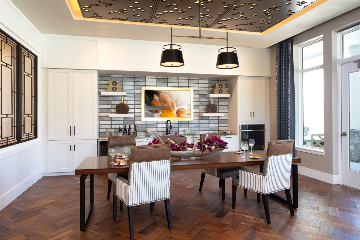 A modern dining room with elegant wooden furniture and stylish pendant lighting.