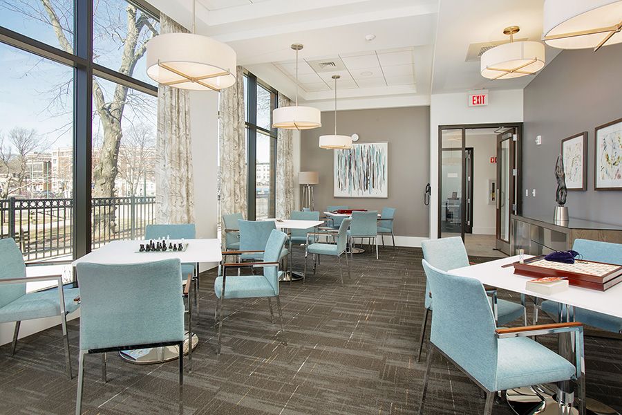A modern dining area with large windows and elegant furnishings.