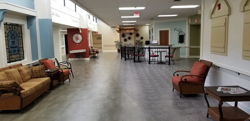 A spacious and modern interior hallway with seating arrangements and decorative elements.