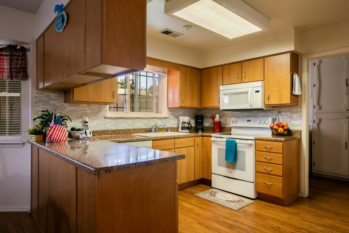 A cozy kitchen with wooden cabinets and modern appliances.