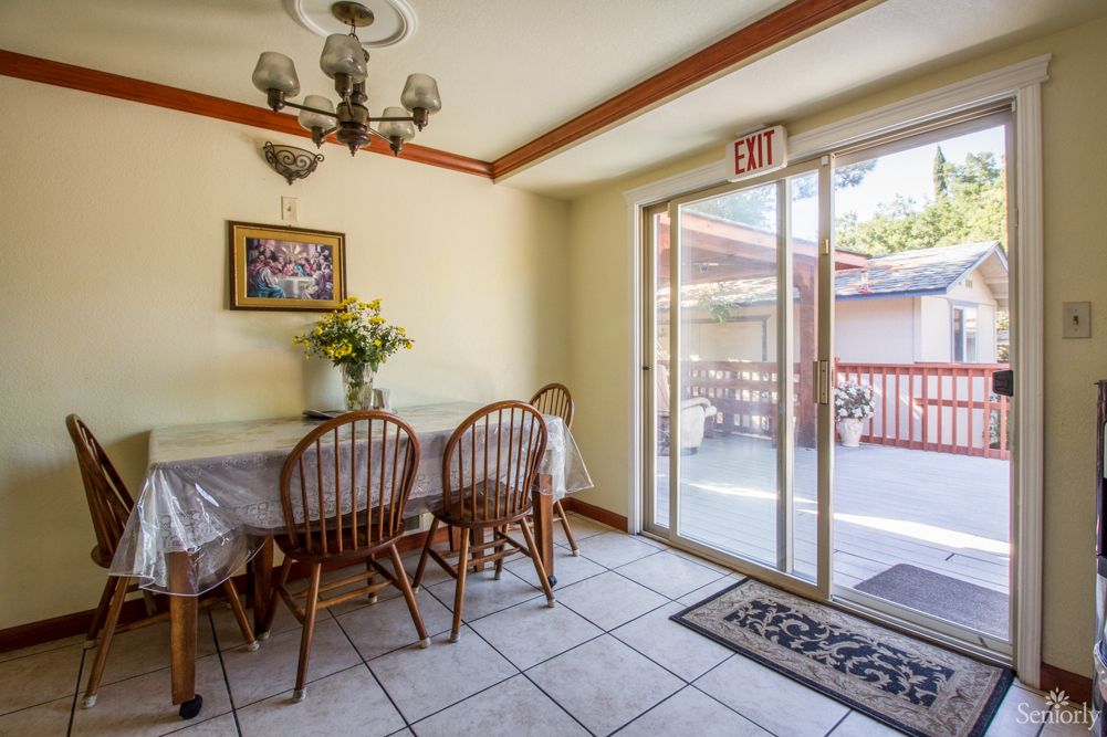 A cozy dining area featuring a table with chairs and a sliding glass door leading to an outdoor deck.