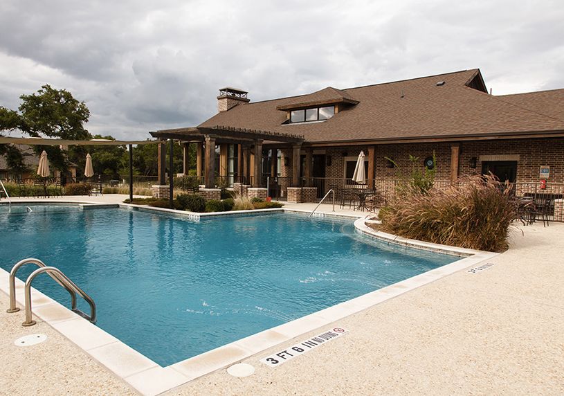 A residential house with an outdoor swimming pool and patio area.