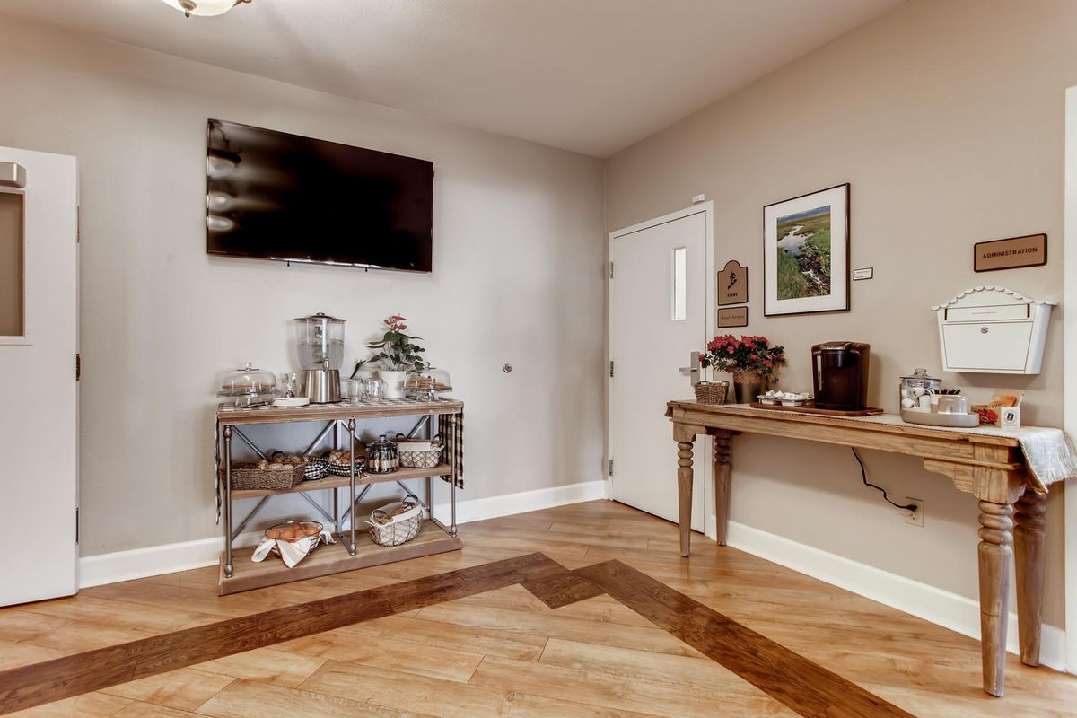A cozy living room interior with a television, console tables, and stylish decor.