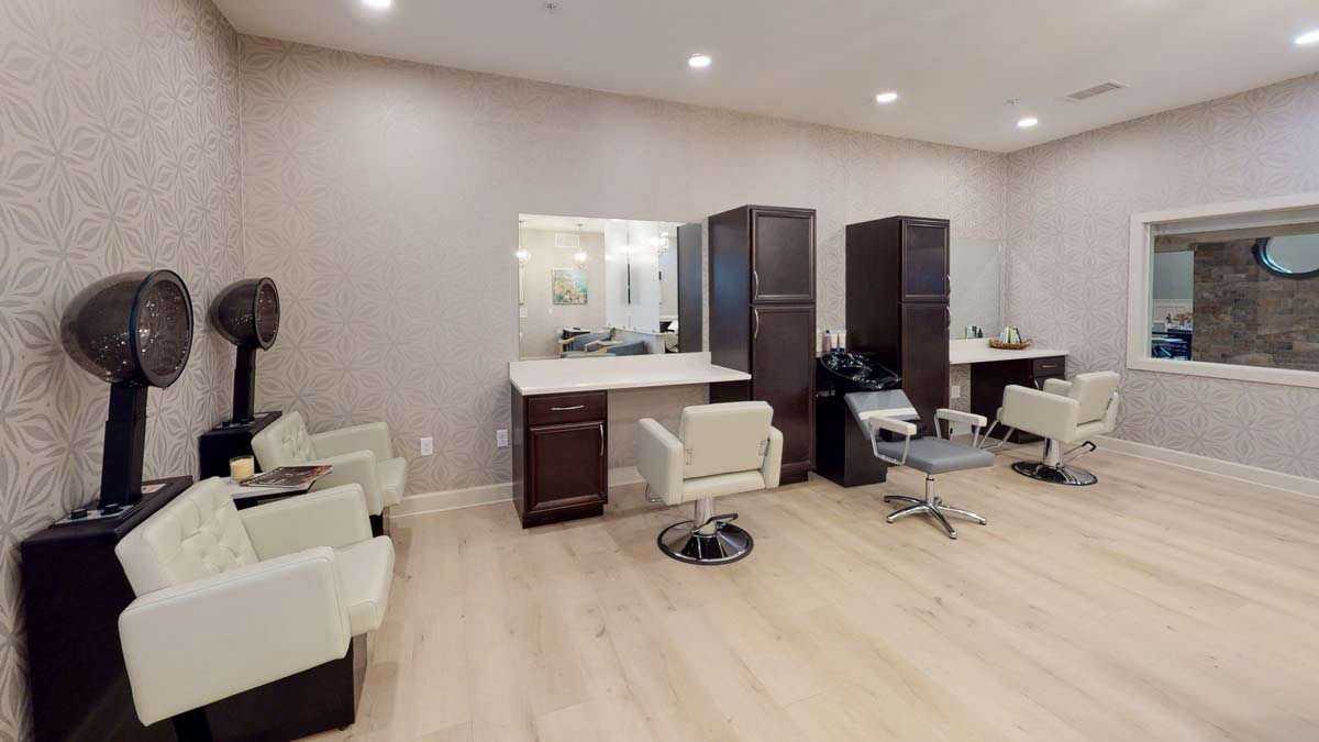 Modern salon interior with hairdressing stations and mirrors.
