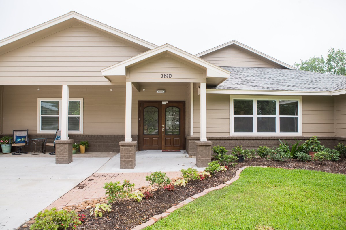 A suburban house with a landscaped front yard.