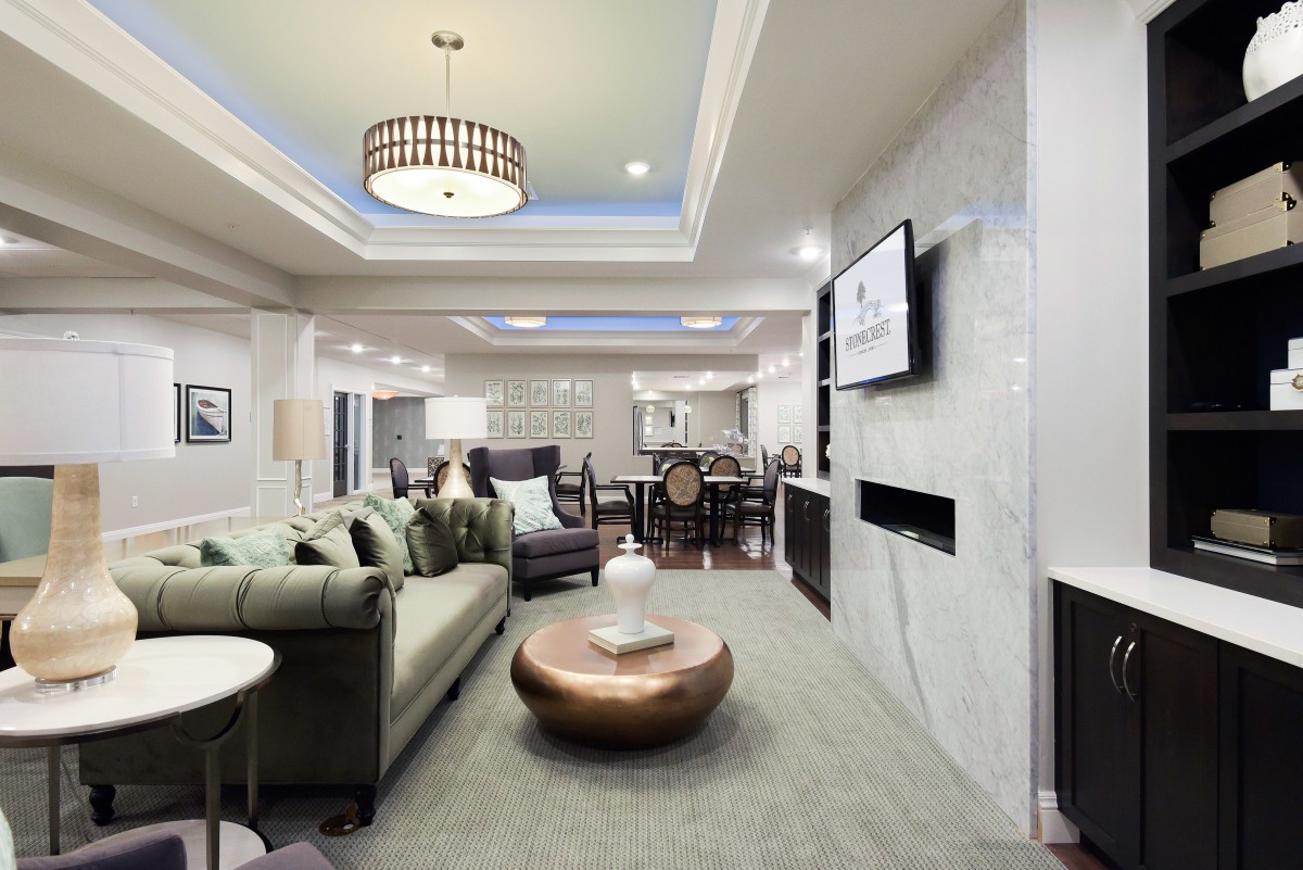 A modern and luxurious open-concept living room with elegant furnishings and ambient lighting.