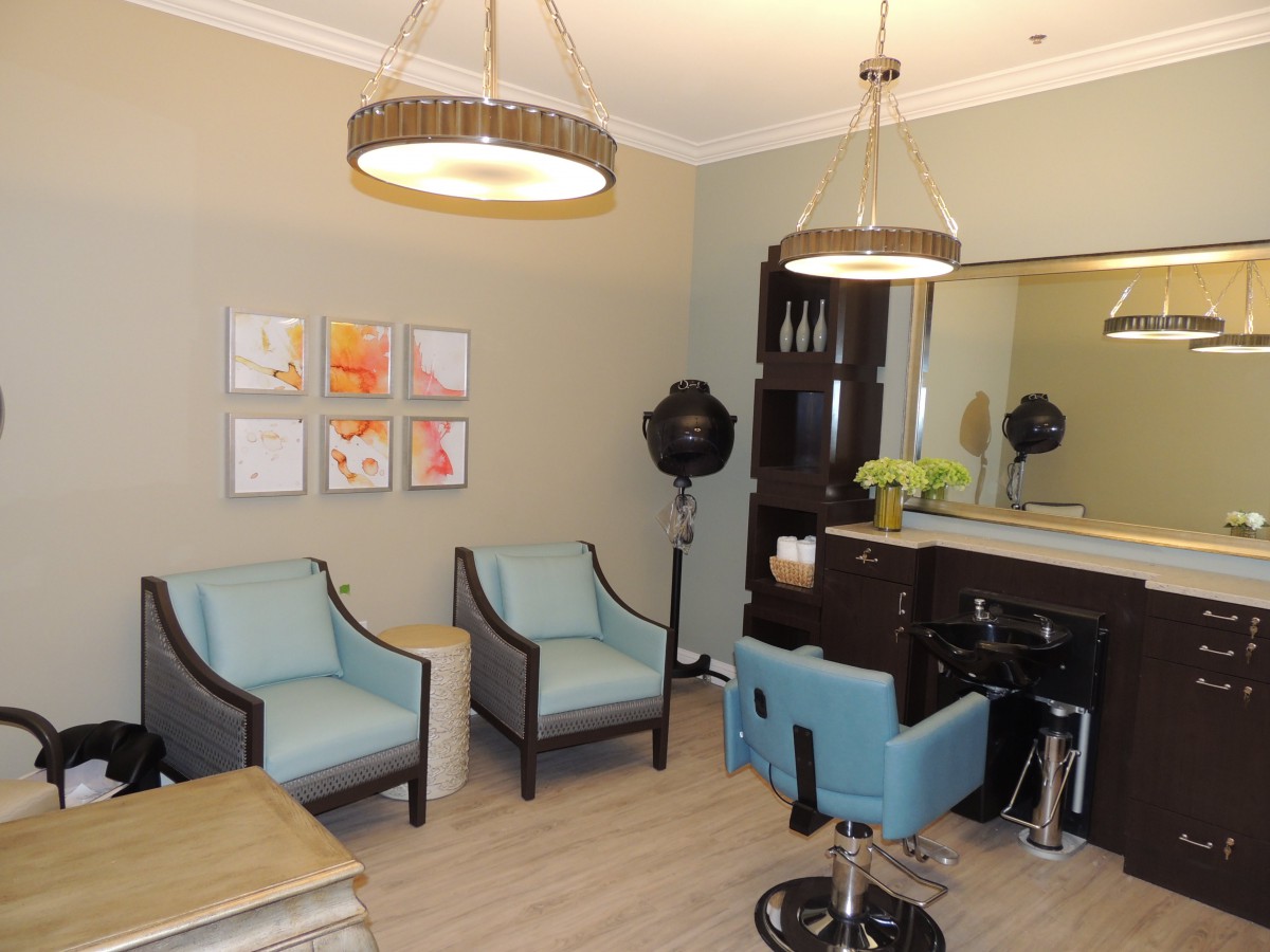 A stylish salon interior with comfortable seating and modern decor.