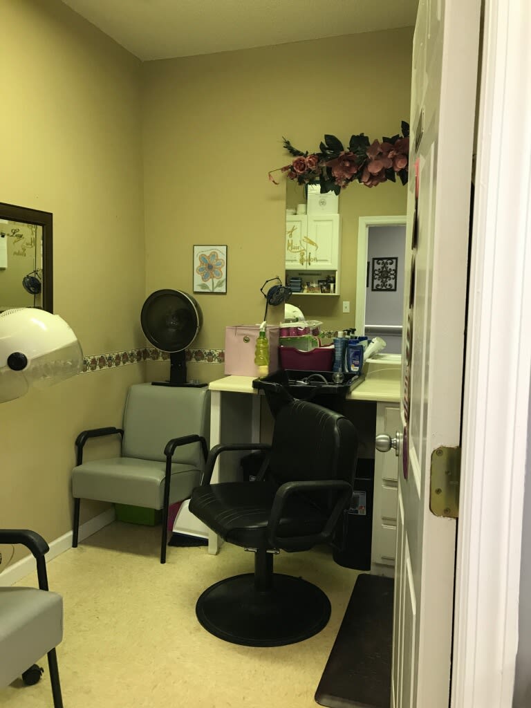 Cozy beauty salon interior with chairs and hair styling equipment.
