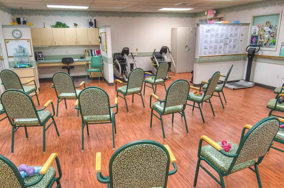 An empty room with chairs arranged in a circle, suggesting a meeting or group activity space.