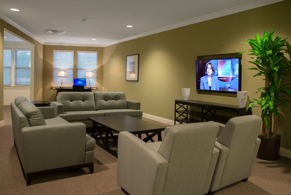 A modern living room with comfortable seating and a large television.