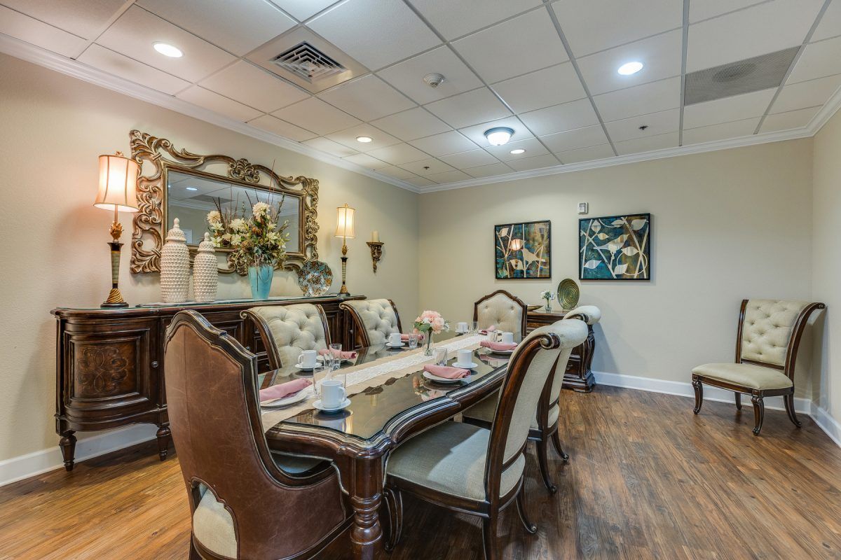 An elegantly decorated dining room with a formal table setting and stylish furnishings.