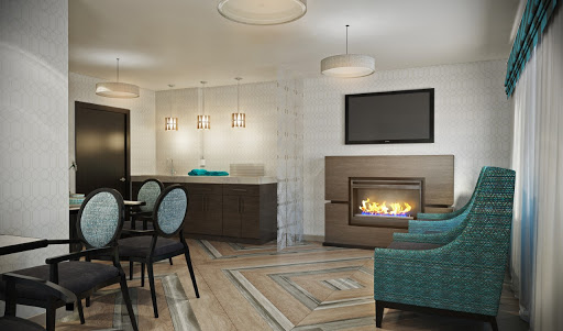 A cozy modern living room featuring a fireplace, stylish furniture, and elegant lighting.