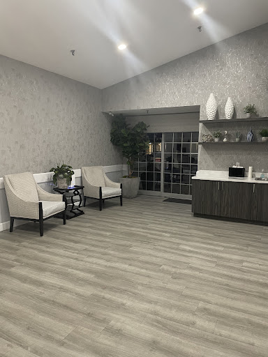 A spacious and modern lobby area featuring comfortable seating, decorative elements, and natural light.