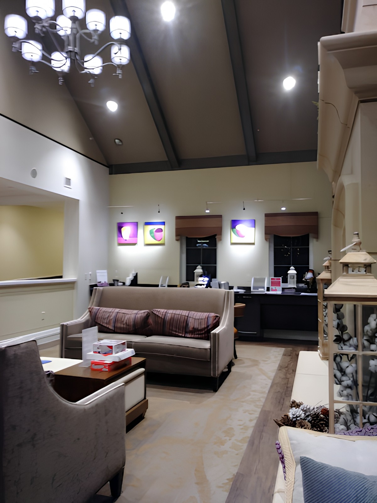 A cozy waiting room with sofas, a coffee table, and decorative elements.