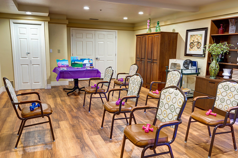A neatly arranged indoor meeting room with chairs and event decorations.