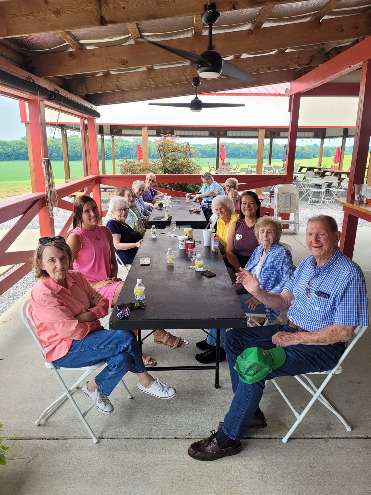 A group of people enjoying a social gathering at an outdoor picnic area.