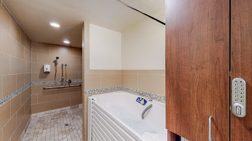 A stylish and modern bathroom featuring a spacious bathtub and elegant tile work.