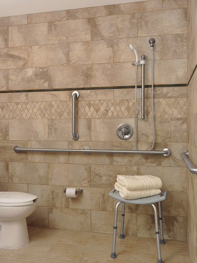 An accessible bathroom equipped with grab bars, a shower chair, and safety features designed for individuals with mobility challenges.