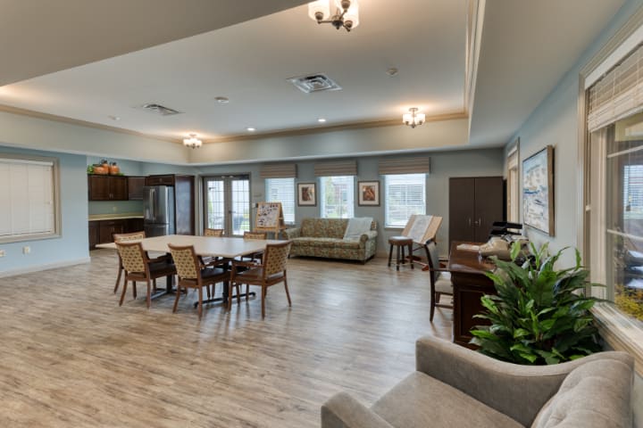 A spacious and modern living and dining area with comfortable seating and natural lighting.