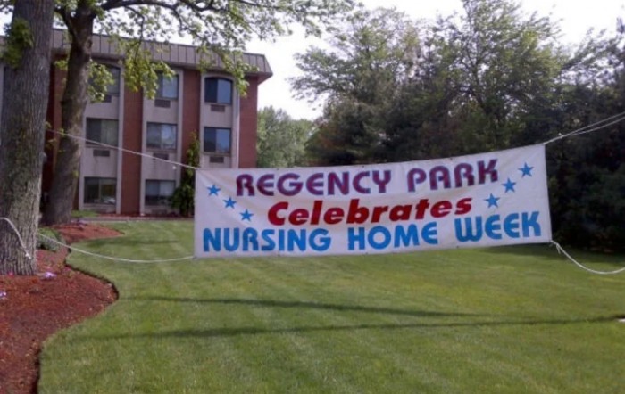 A banner in front of a building celebrating Nursing Home Week at Regency Park.