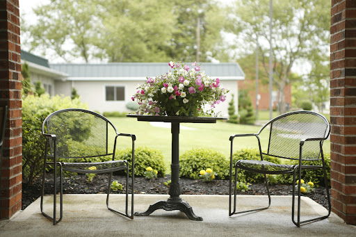 A serene outdoor seating area adorned with a floral centerpiece.
