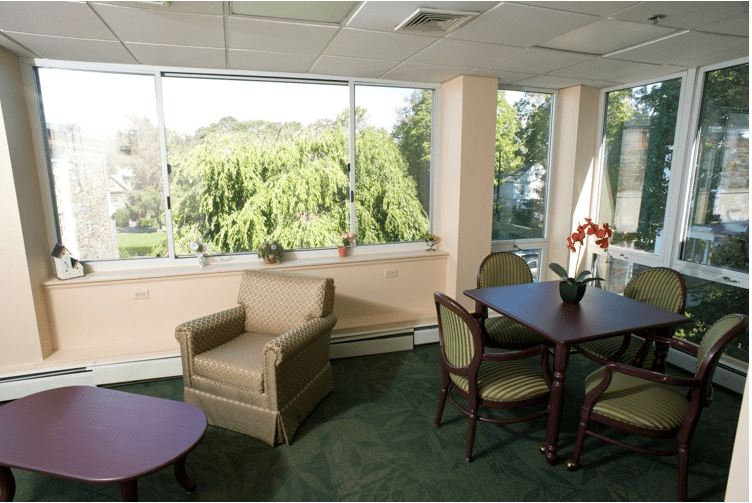 A cozy living room with large windows and comfortable seating.