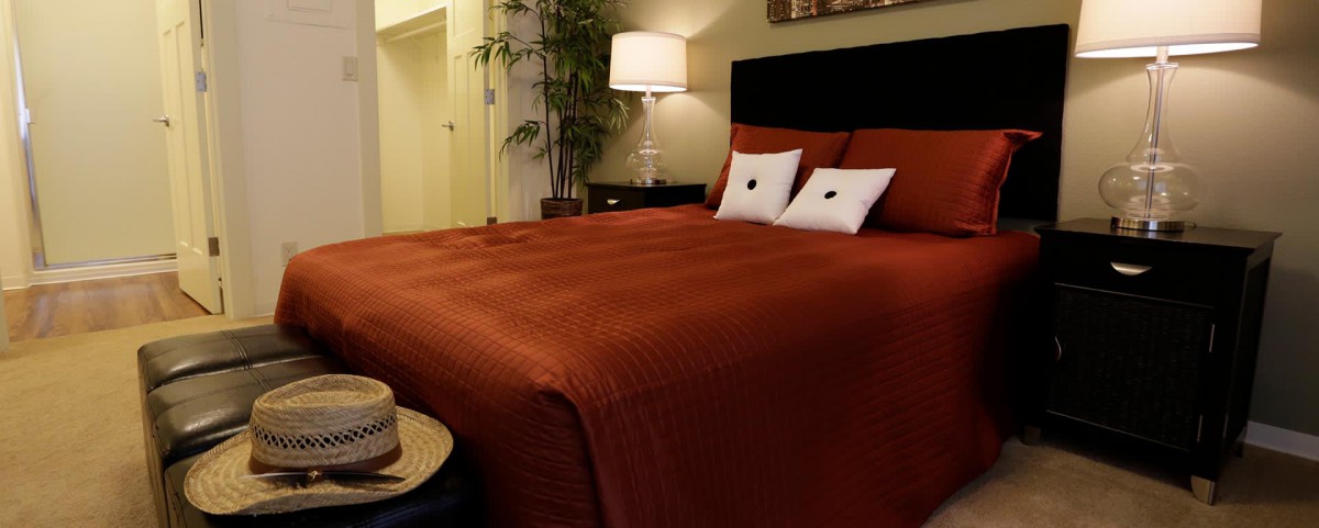 A cozy bedroom with a warm color scheme and modern decor.