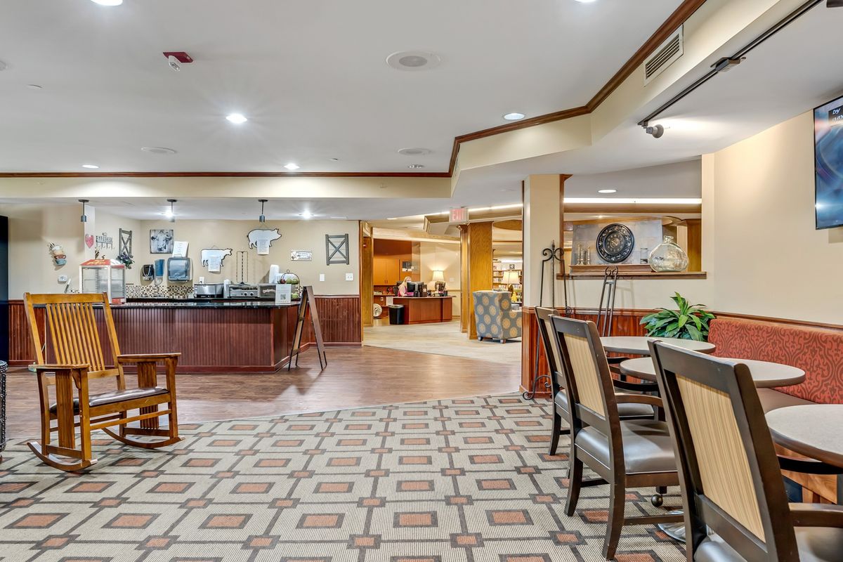 A spacious hotel lobby with a reception desk and comfortable seating area.
