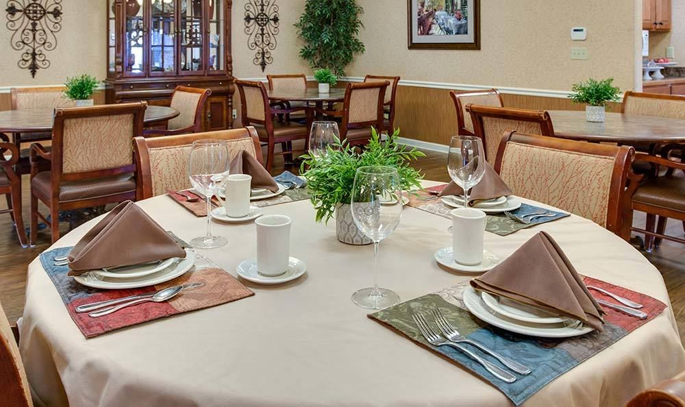 An elegantly set dining table in a cozy restaurant interior.