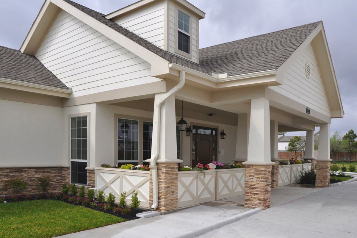 A modern residential house with a welcoming porch and driveway.