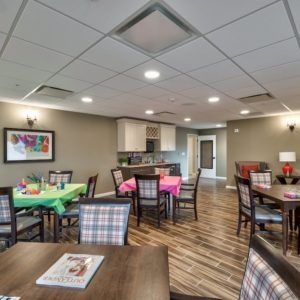 A well-lit dining area with multiple tables and chairs, featuring a modern and inviting design.
