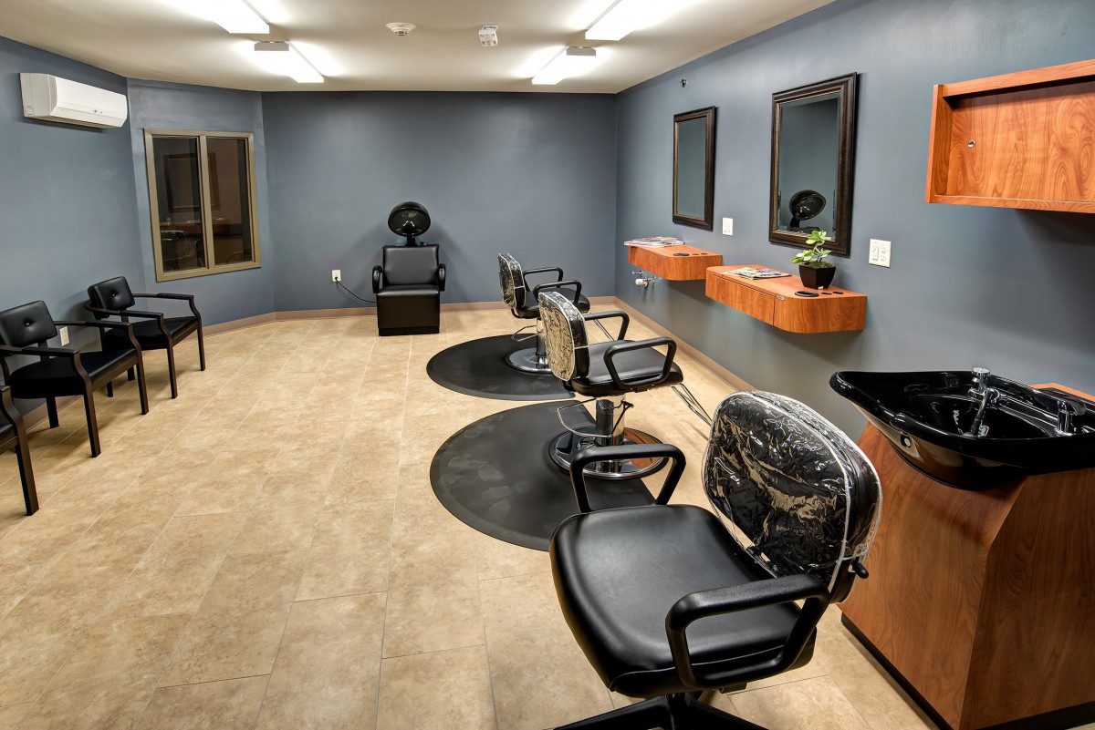 Empty modern hair salon with chairs and mirrors.
